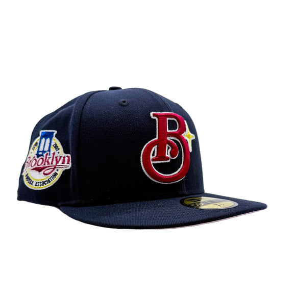 A navy blue New Era 59FIFTY fitted baseball cap featuring a red and white embroidered 'Brooklyn Bodega Association' logo on the front and a BBA patch on the side.