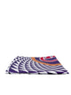 A folded square fabric item, likely a scarf or pocket square, featuring a bold geometric pattern of purple, white, and black concentric arches, with a red and gold circular emblem on the right side, set against a plain light gray background.