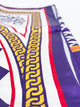 A close-up of a patterned scarf featuring purple, white, red, and yellow Greek key and geometric designs.